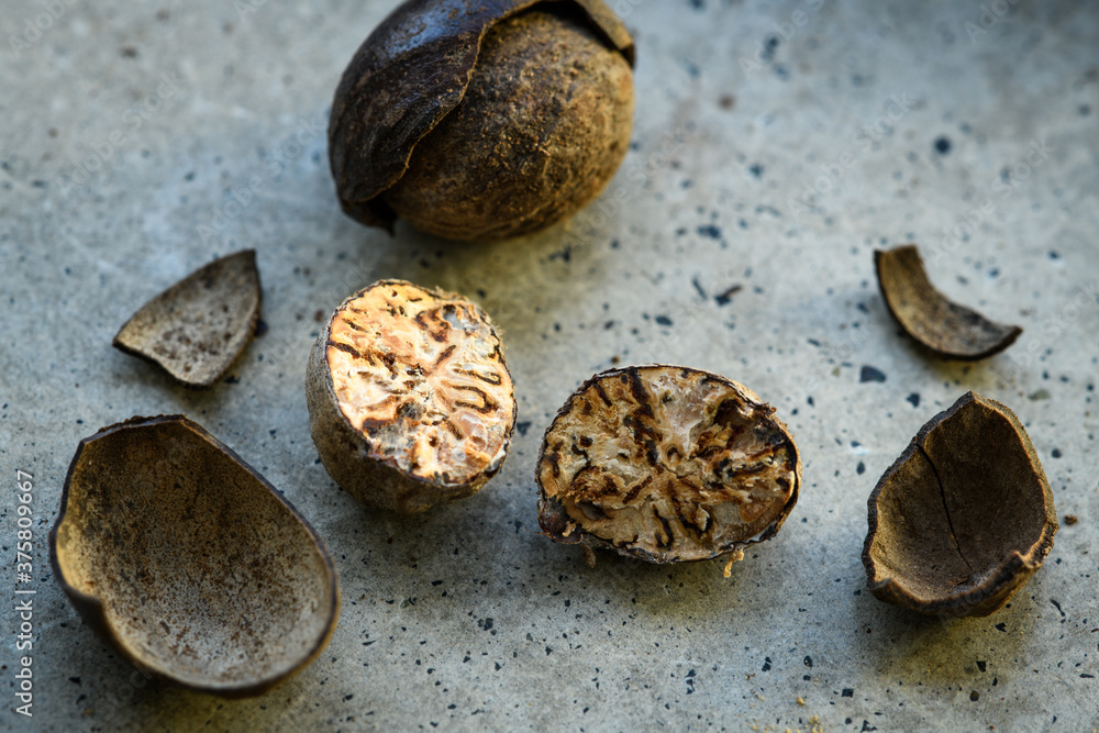 Cut nutmeg on a concrete table Cut nutmeg on a concrete table