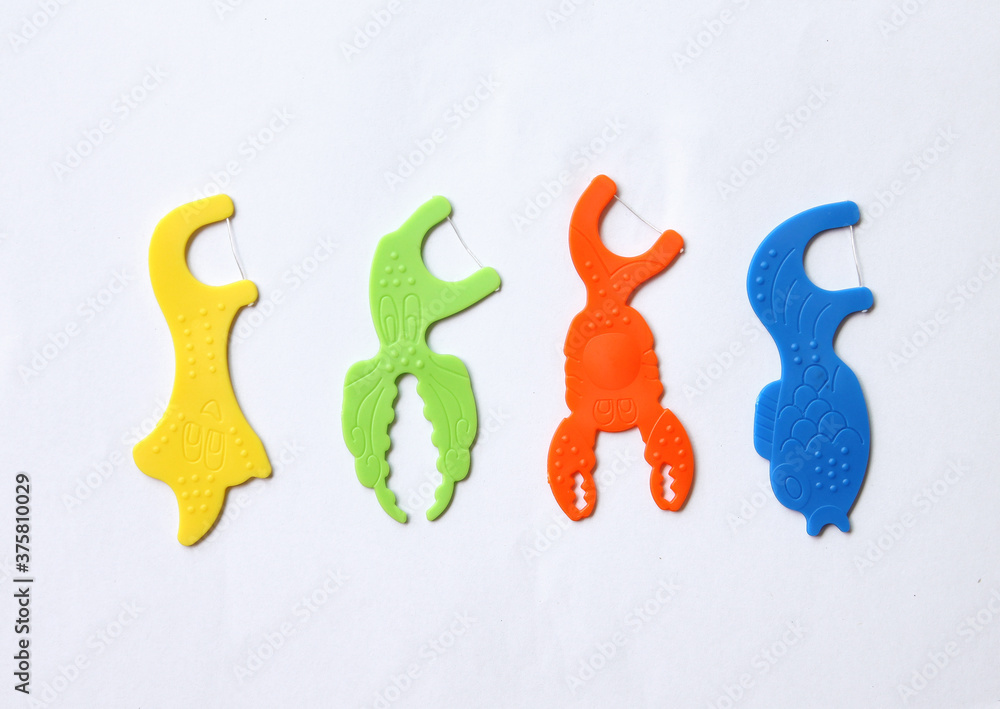 Set of colorful dental floss sticks isolated on a white background. Set of colorful dental floss sticks isolated on a white background.