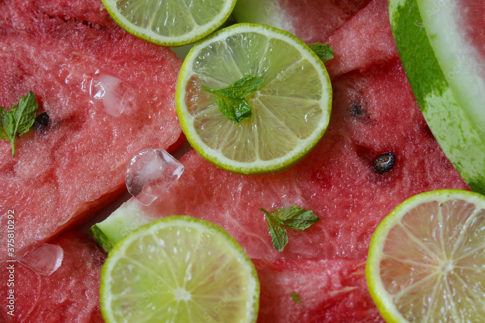 Watermelon slices close-up with lime slices and mint leaves Watermelon slices close-up with lime slices and mint leaves