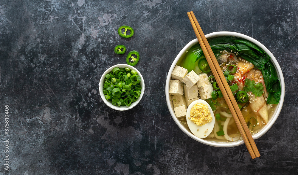 Traditional asian noodle soup Udon with tofu, bok choy cabbage, and kimchi. Vegetarian recipe. Copy space. Traditional asian noodle soup Udon with tofu, bok choy cabbage, and kimchi. Vegetarian recipe. Copy space.