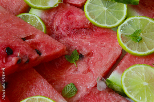 Sliced slices of juicy watermelon close-up with lime and mint