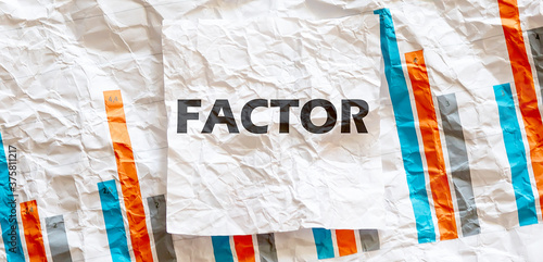 FACTOR word text on the white memo note crupled sticker on chart background photo