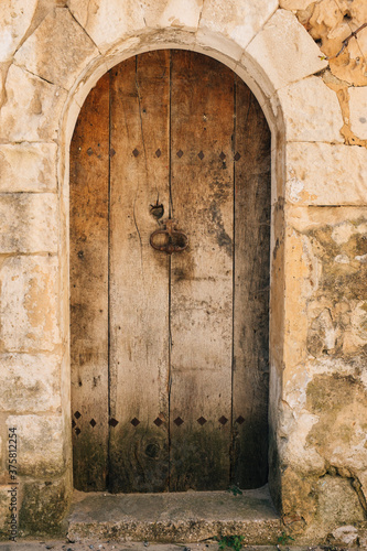 Old and weathered doorway to residential home, Goult, France photo