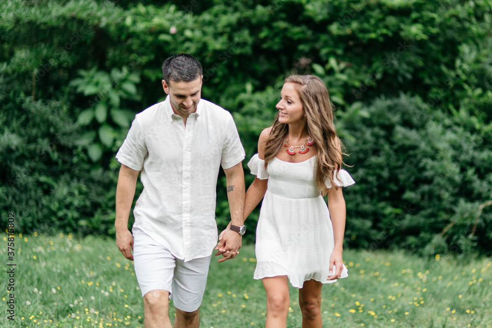 Attracting young couple walking and holding hands Attracting young couple walking and holding hands