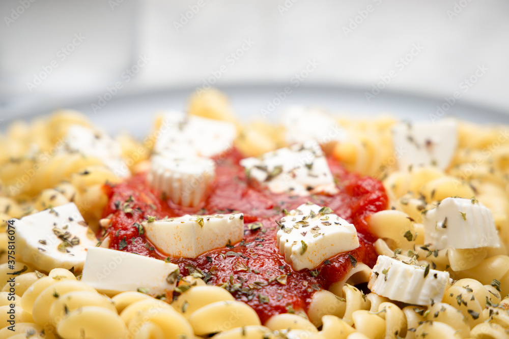 Close up of pasta with tomato sauce and cheese Close up of pasta with tomato sauce and cheese