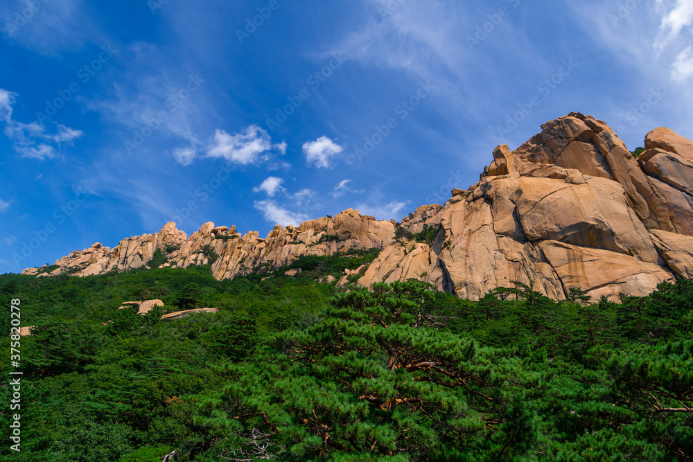 The rocky, mountainous landscape of Ulsan Bawi Rock from below. From Seoraksan National Park in Sokcho, South Korea. 