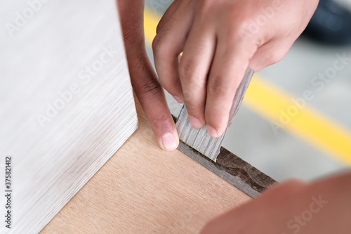 Young carpenter applying edging strips