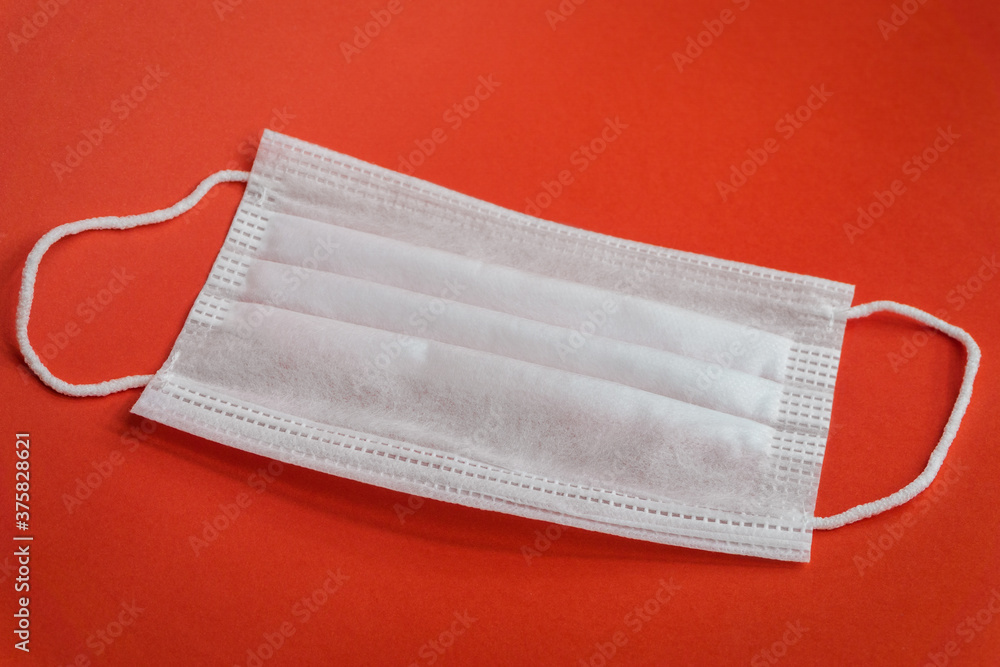 Protective face mask isolated on red background. Coronavirus concept and background. Protective face mask isolated on red background. Coronavirus concept and background.