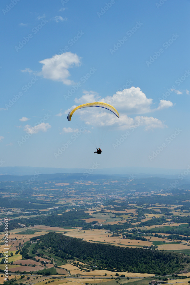 Man paragliding over the countryside Man paragliding over the countryside