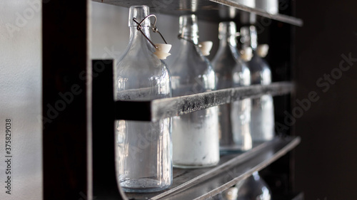 Transparent glass bottles on the shelves