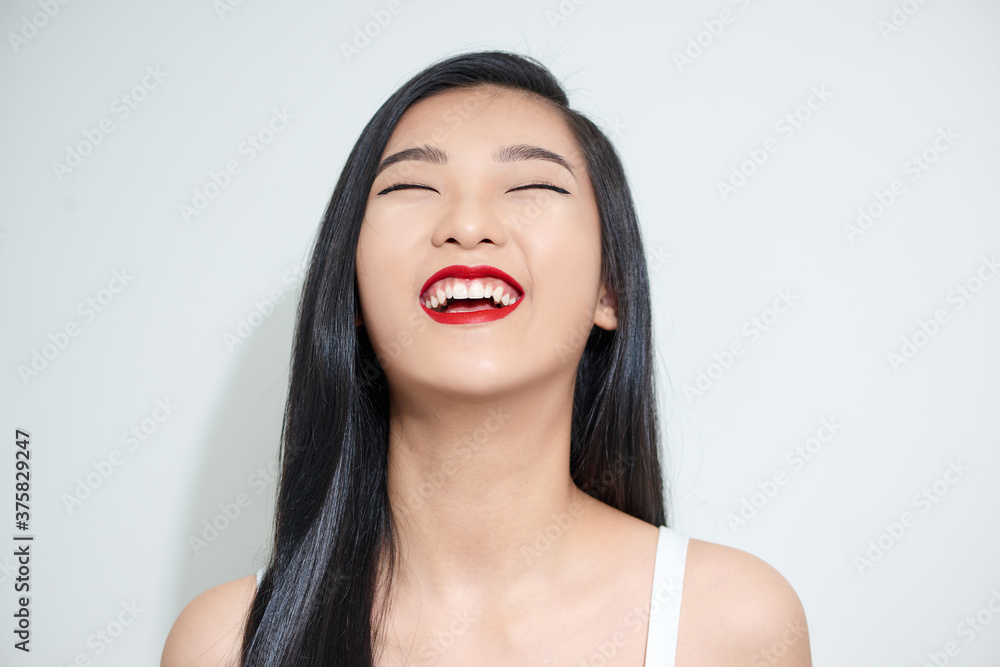 Asian woman relaxing and happy smiling woman in casual clothes on white background Asian woman relaxing and happy smiling woman in casual clothes on white background