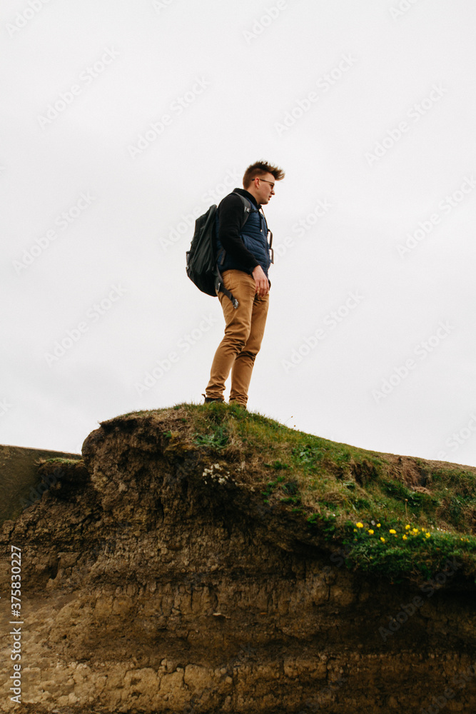 Young male outdoors in nature at cliffs of Moher in ireland Young male outdoors in nature at cliffs of Moher in ireland