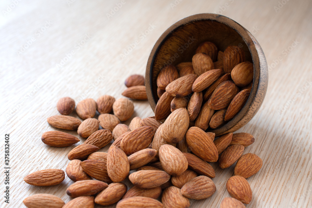 Close up,Almonds on the wood background,copy space. Close up,Almonds on the wood background,copy space.