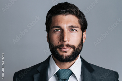 portrait of full bearded well dressed young business man photo