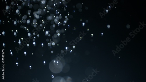 Shower and douche concept overlay mockup 3D illustration plate of downpour water droplets with strong bokeh blur. Fountain of drops in soft selective macro focus against black background.