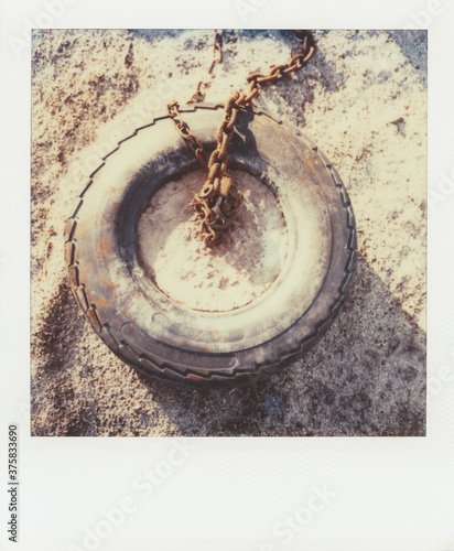 Discarded tire on beach (Polaroid SX-70 print) photo