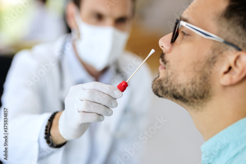 Close-up of a man having PCR test at medical clinic.