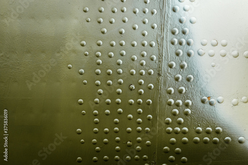 ARMOR PLATING of an airplane or helicopter. Large rivets on metal