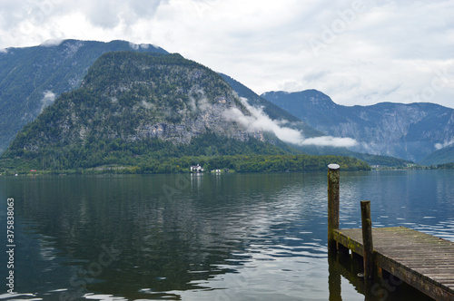 Wooden pier and dock at Hallstatter see lake in Austria with mountains in background