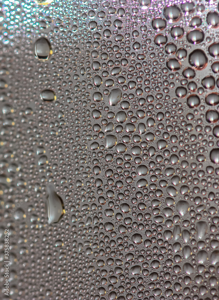 Many colorful little bubbles on the glass surface close-up Many colorful little bubbles on the glass surface close-up