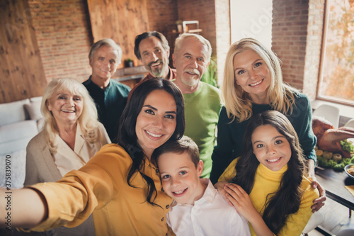 Closeup portrait photo of full big family gathering eight people make selfie cuddle embrace wait pray thank god have good autumn time make wish generation in home evening living room indoors