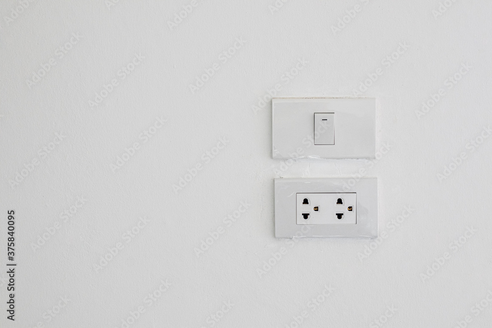 Electrical switches and sockets on white wall background. Electrical switches and sockets on white wall background.