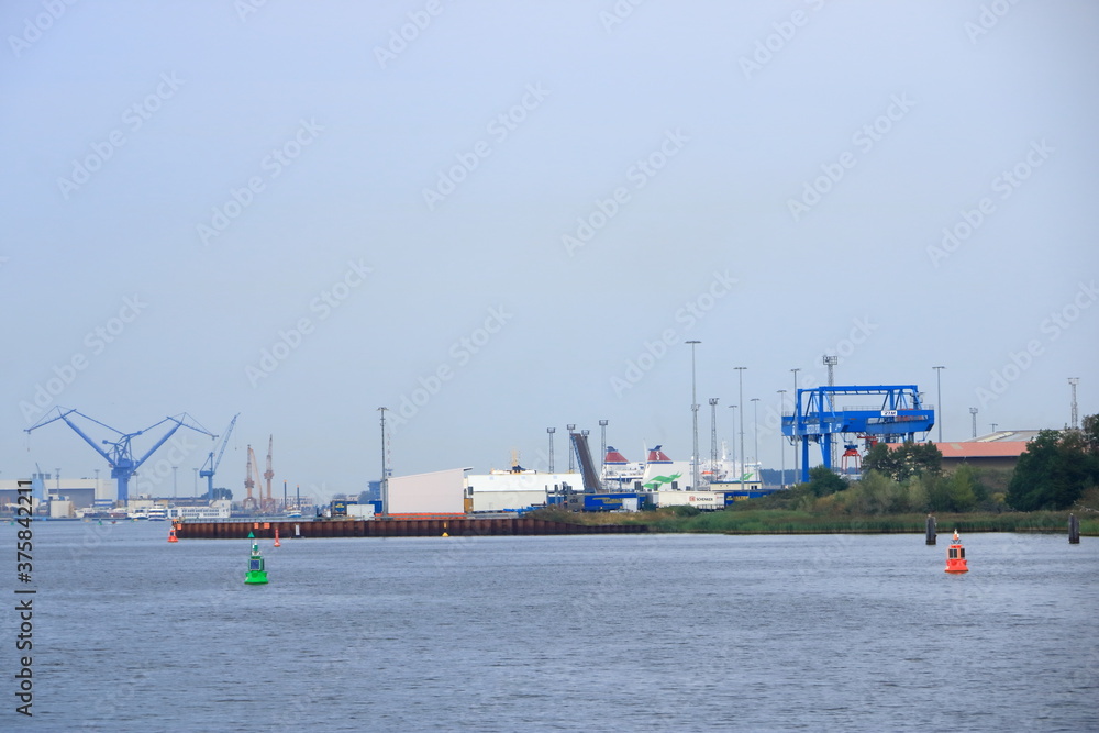 Fototapeta premium August 21 2020 - Rostock-Warnemünde, Mecklenburg-Vorpommern/Germany: A ferry arrives at the port of Rostock