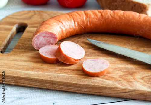 Slices of chicken sausage on a wooden board
