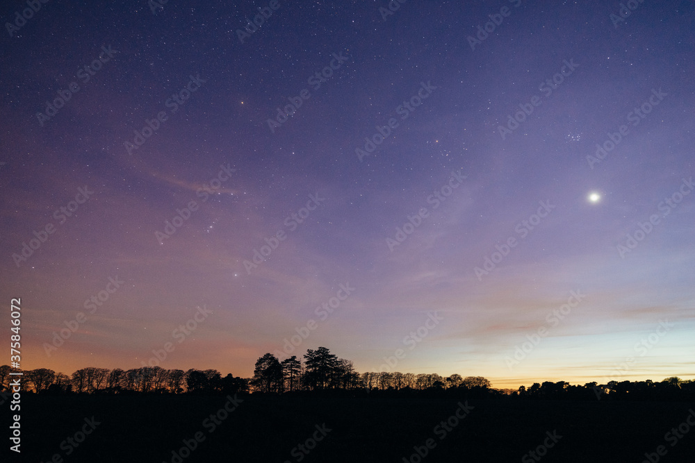 Venus, The Pleiades and Orion over rural landscape at night. Venus, The Pleiades and Orion over rural landscape at night.