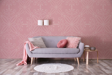 Modern room interior with sofa near patterned wallpapers