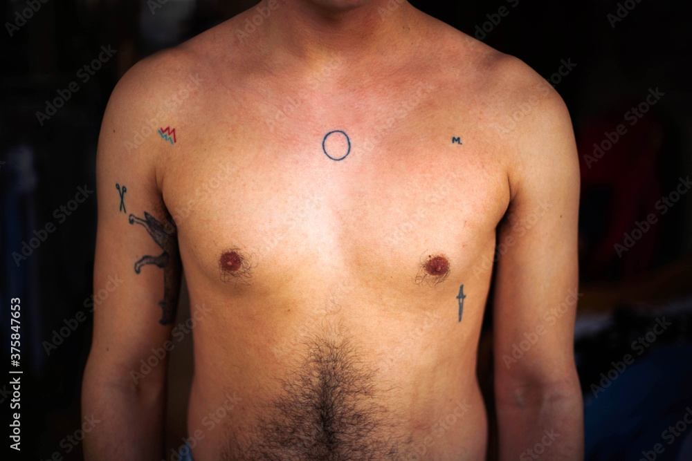 Male tattooed body indoors Male tattooed body indoors