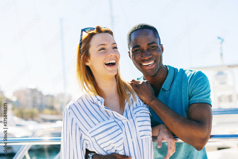 Young multiethnic couple enjoying a sunny day on a luxurious yacht. Young multiethnic couple enjoying a sunny day on a luxurious yacht.