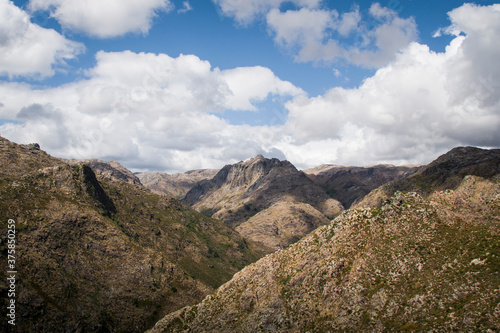 Clouds over wide mountain landscape © Ana