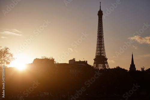 Cityscape of Paris, France and famous landmark Eiffel tower in silhouette just before sunset. © astrosystem