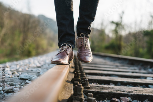 Man walking along the railroad photo