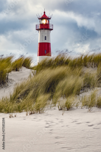 Lighthouse and beach grass on a windy day