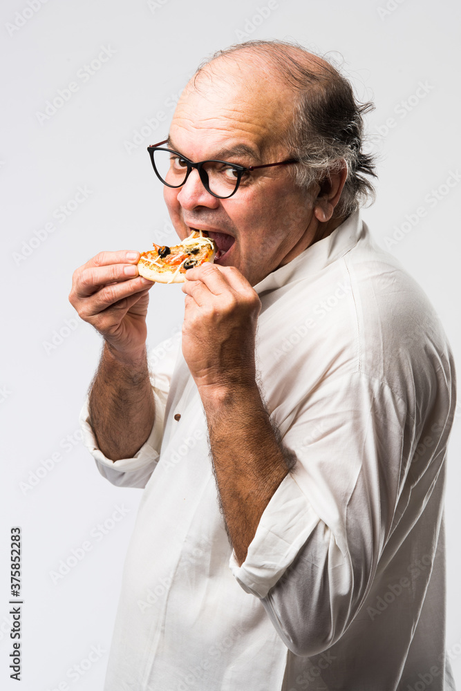 Asian Indian old man eating pizza with funny expressions Stock Photo | Adobe Stock Asian Indian old man eating pizza with funny expressions Stock Photo | Adobe Stock