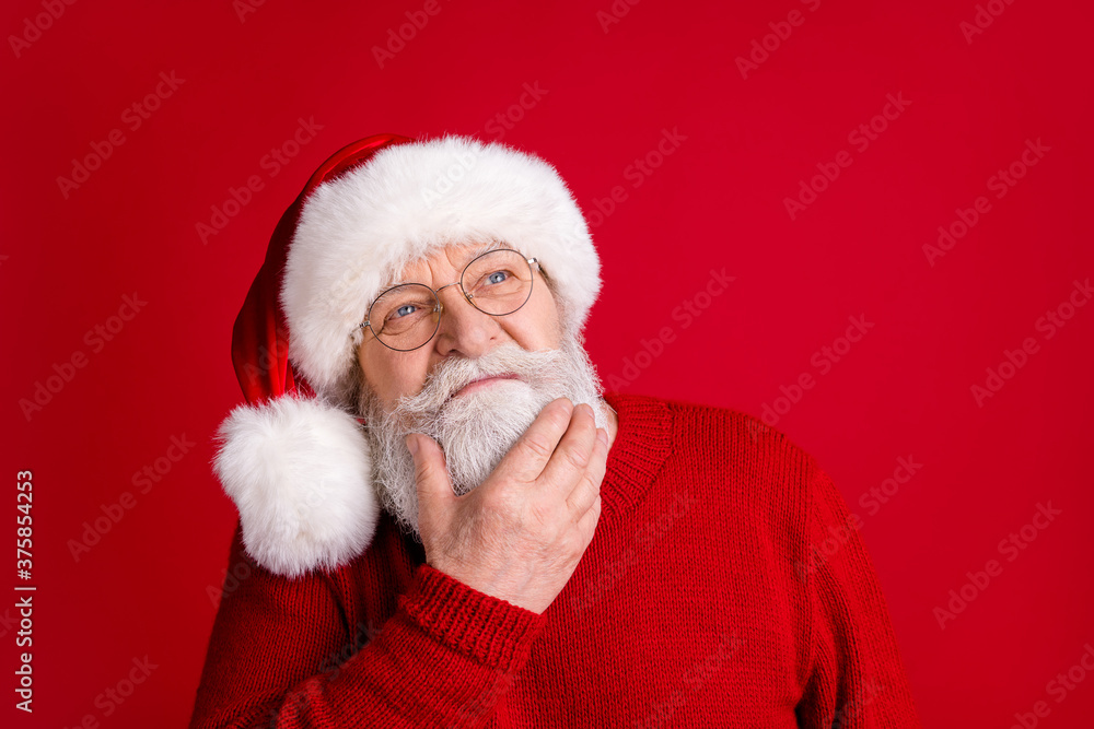 Close up portrait of unsure pensive old man in santa claus headwear look copyspace touch hand chin think x-mas newyear gifts wear shine sweater isolated bright color background Close up portrait of unsure pensive old man in santa claus headwear look copyspace touch hand chin think x-mas newyear gifts wear shine sweater isolated bright color background