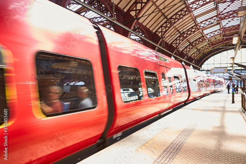 A train at a train-station going fast