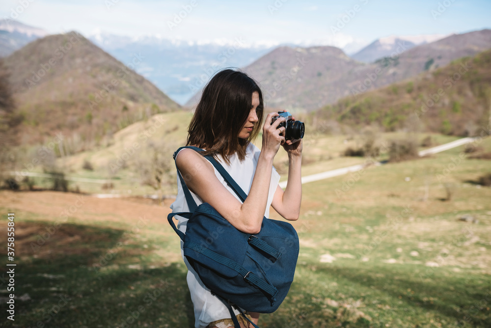 Young woman taking pictures in mountain Young woman taking pictures in mountain