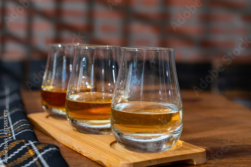 Photography Tasting of Scotch whisky in traditional old house with shadow from British windo