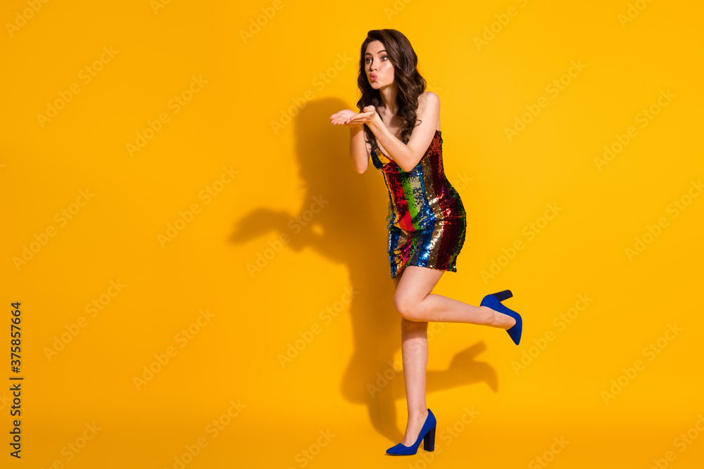 Full length body size profile side view of her she nice attractive lovely charming wavy-haired lady sending air kiss romance amour isolated bright vivid shine vibrant yellow color background