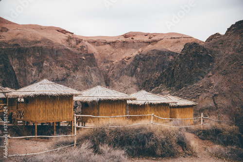 Straw houses in a canyon photo