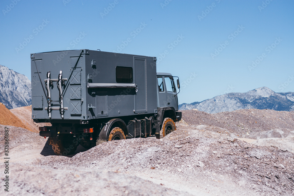 grey offroad truck in rugged landscape grey offroad truck in rugged landscape