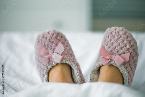 lying in bed with slippers photo