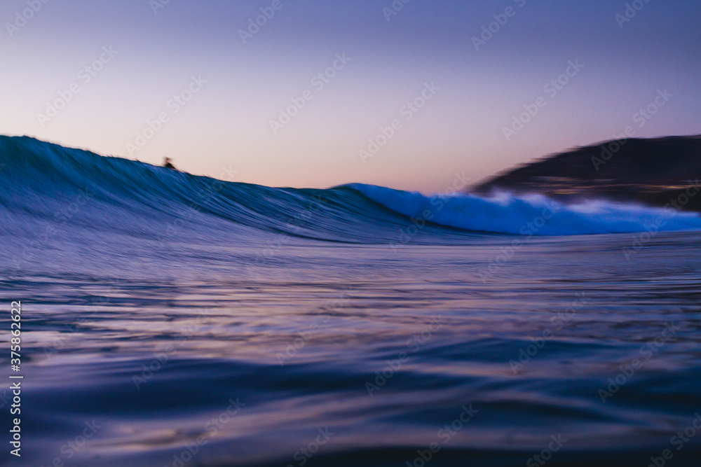 Low angle water shot of a breaking wave at sunset in southern California. Low angle water shot of a breaking wave at sunset in southern California.