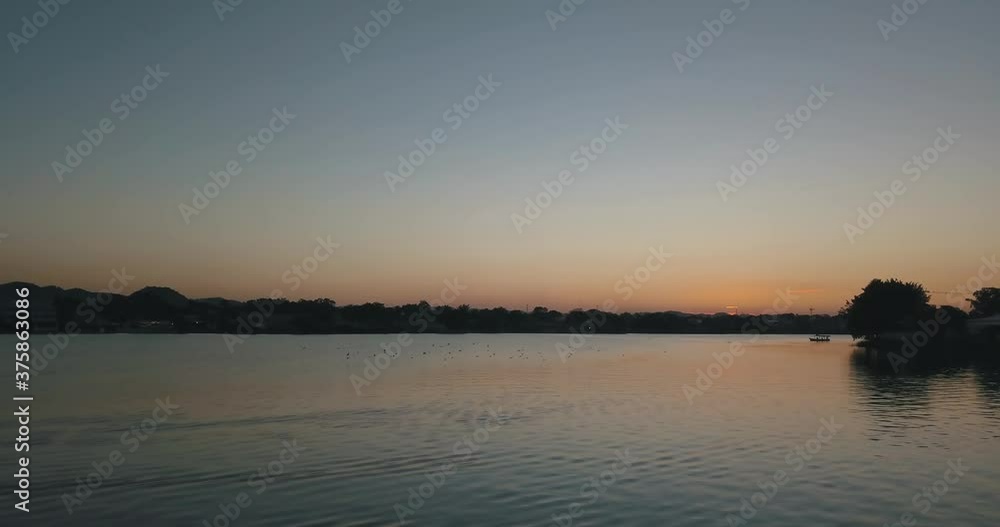 Drone aerial shot flying low close to the lake and birds during sunset in Peten, Guatemala Drone aerial shot flying low close to the lake and birds during sunset in Peten, Guatemala