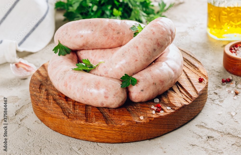 Raw chicken sausage for grilled on wooden cutting board with parsley. Raw chicken sausage for grilled on wooden cutting board with parsley.
