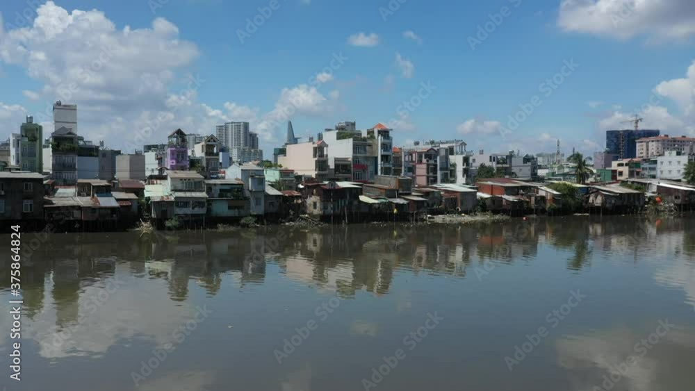 Old and new buildings along the Kenh Te Canal. This waterway connects The Mekong Delta to the Saigon River in Ho Chi Minh City, Vietnam. It is an important transport route for food and other goods. Old and new buildings along the Kenh Te Canal. This waterway connects The Mekong Delta to the Saigon River in Ho Chi Minh City, Vietnam. It is an important transport route for food and other goods.