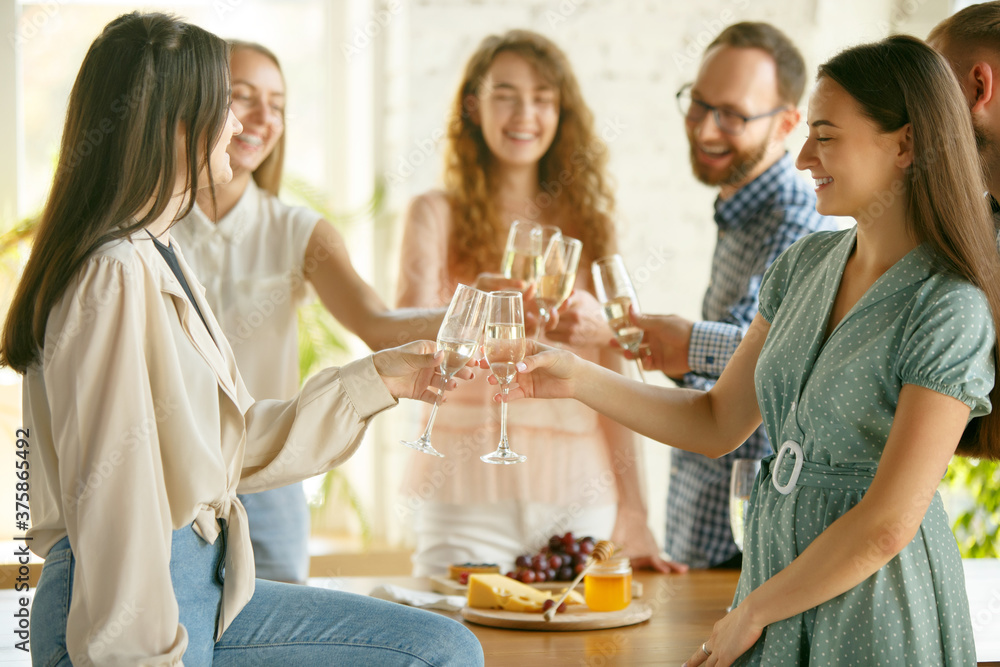 Team. People clinking glasses with wine or champagne. Happy cheerful friends celebrate holidays, meeting. Close up shot of smiling friends, lifestyle. Party at home or in restaurant, cafe. Team. People clinking glasses with wine or champagne. Happy cheerful friends celebrate holidays, meeting. Close up shot of smiling friends, lifestyle. Party at home or in restaurant, cafe.